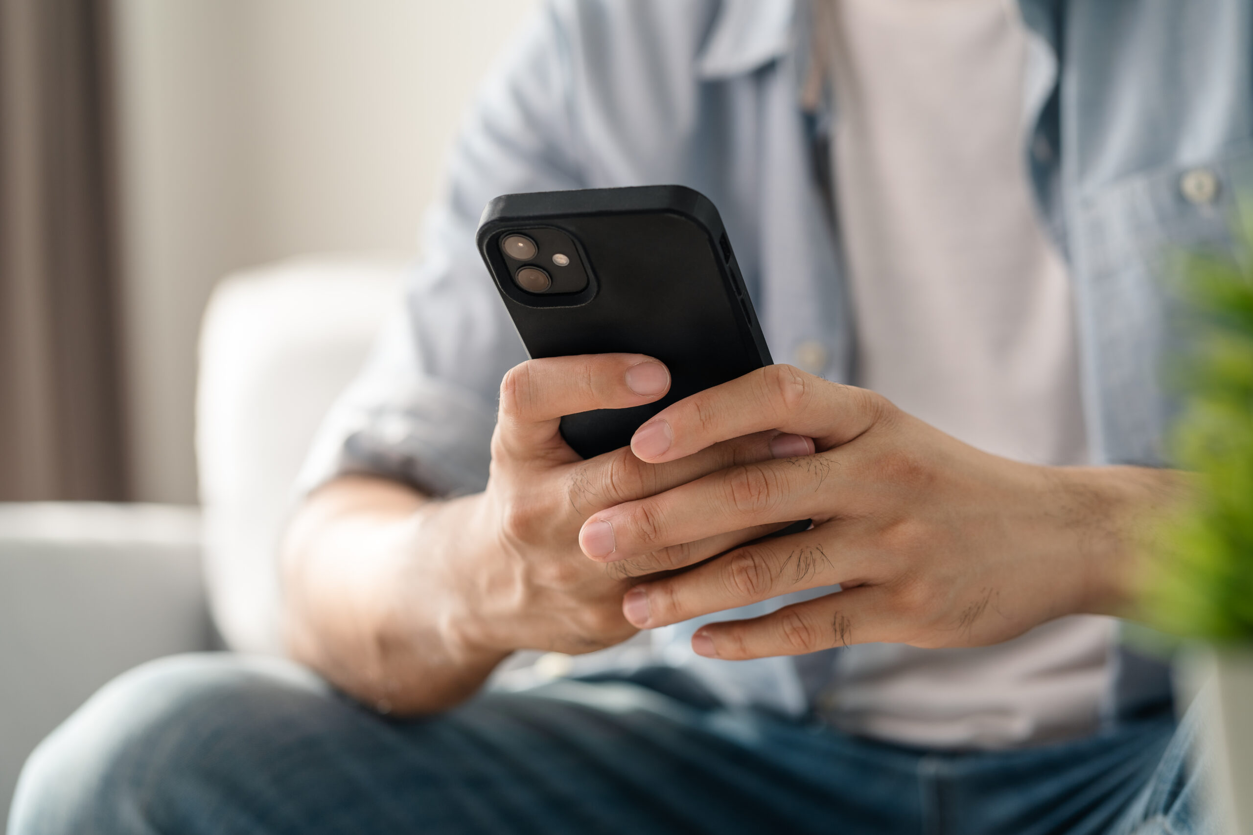 Man using smartphone typing, chatting conversation, watching video live streaming. Social network, technology concept